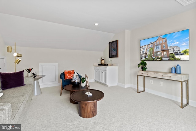 living room with light colored carpet and vaulted ceiling