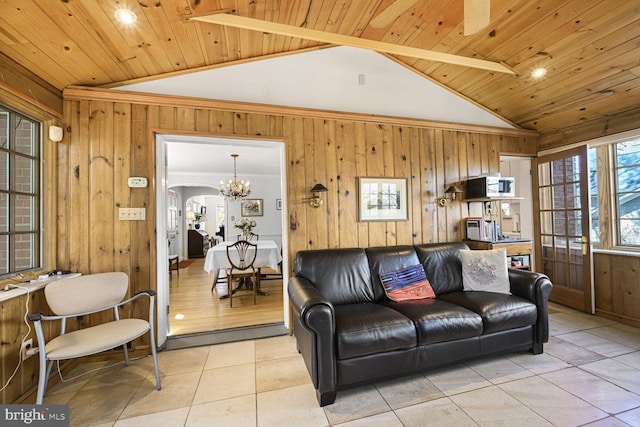 living area with vaulted ceiling, wooden ceiling, light tile patterned flooring, and wood walls