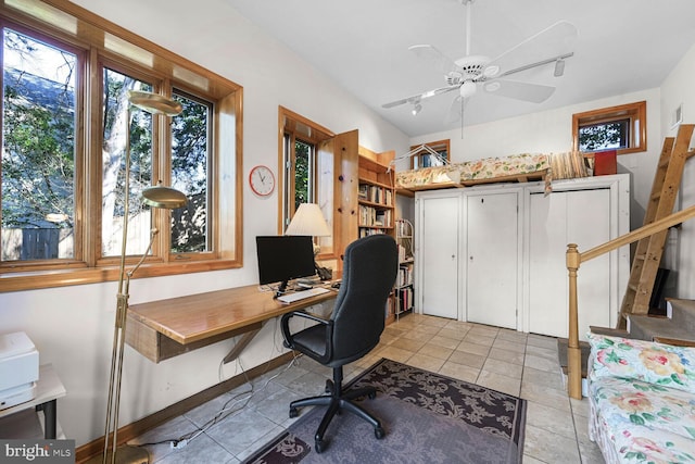 office space with light tile patterned floors, a ceiling fan, rail lighting, and baseboards