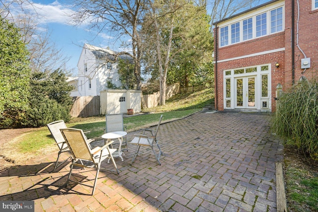 view of patio with a shed, a fenced backyard, and an outdoor structure