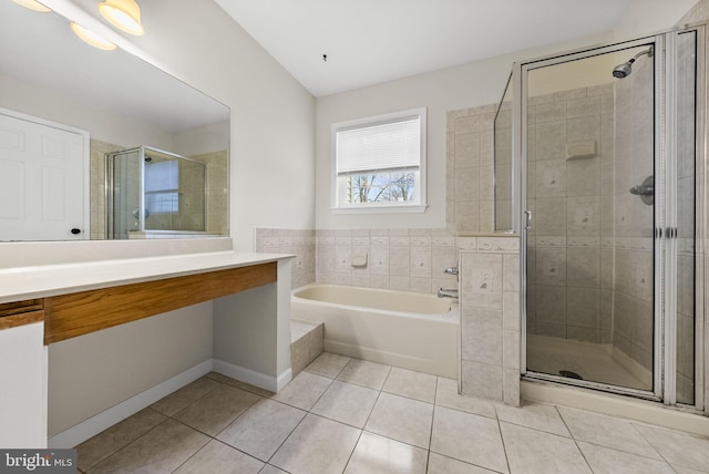 bathroom with a stall shower, baseboards, tile patterned flooring, vanity, and a bath