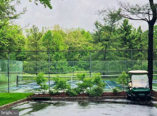 view of sport court featuring fence