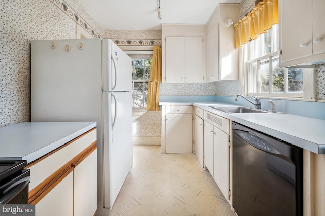 kitchen featuring a sink, white cabinetry, light countertops, and dishwasher