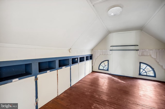 bonus room featuring dark wood-type flooring and vaulted ceiling