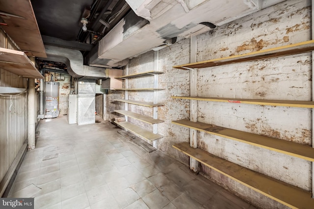 unfinished basement featuring water heater