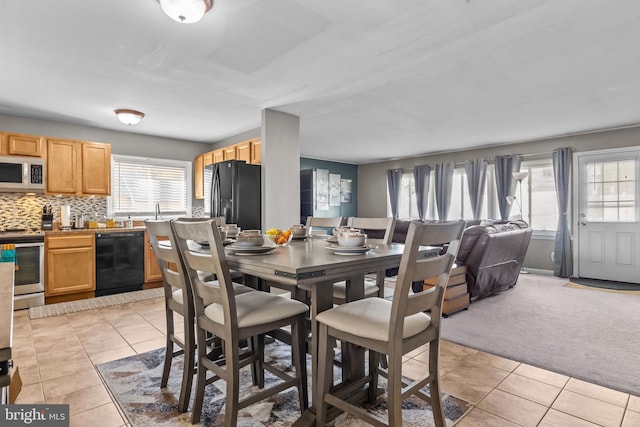 dining room with light colored carpet