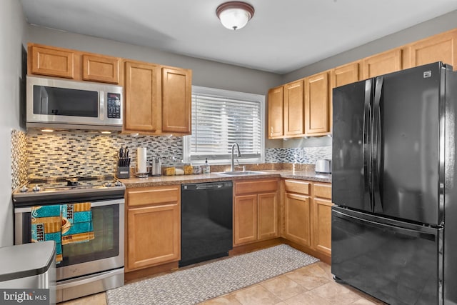 kitchen featuring sink, black appliances, light tile patterned flooring, decorative backsplash, and light brown cabinets