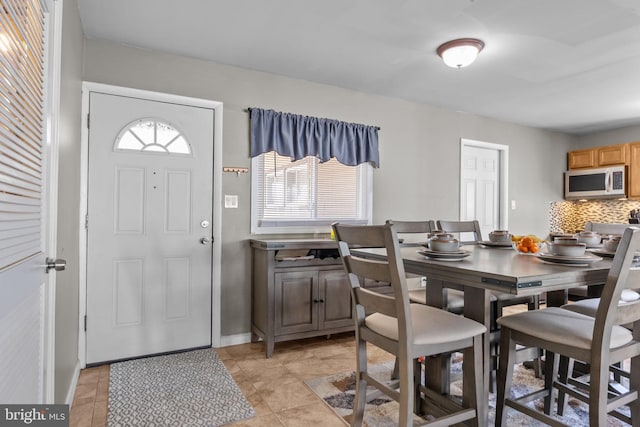 dining area with light tile patterned floors