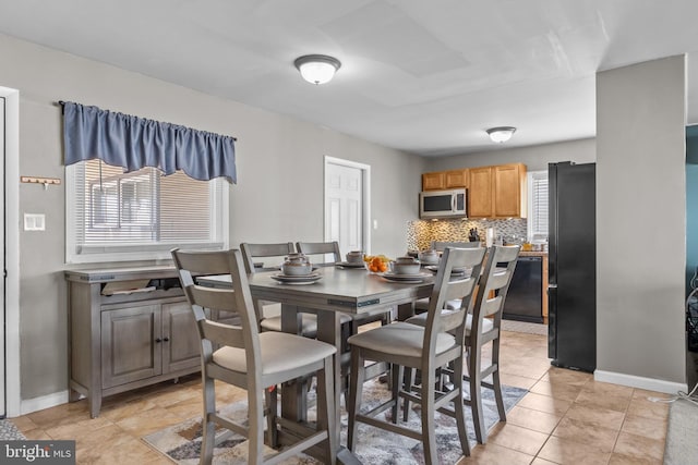 dining space featuring light tile patterned flooring