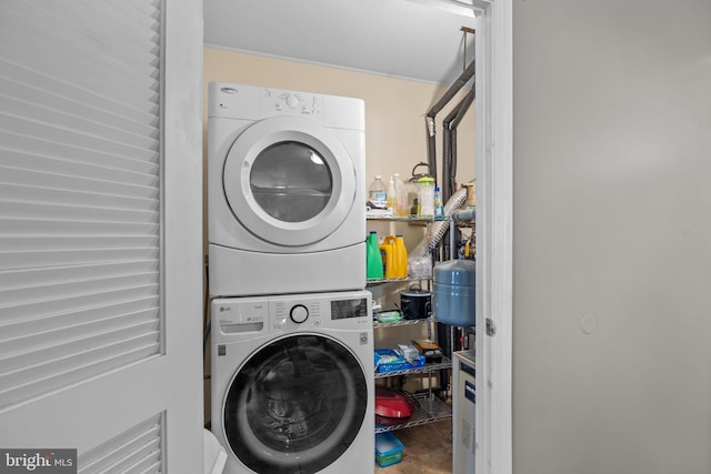 laundry area with stacked washer and dryer