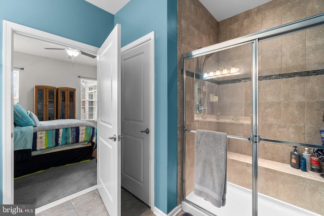 bathroom with ceiling fan, an enclosed shower, and tile patterned flooring