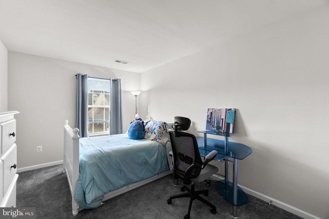 bedroom with dark colored carpet