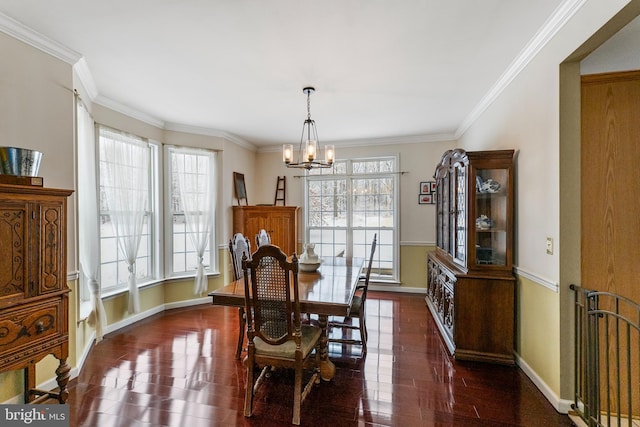 dining room with ornamental molding, a healthy amount of sunlight, dark hardwood / wood-style floors, and a chandelier