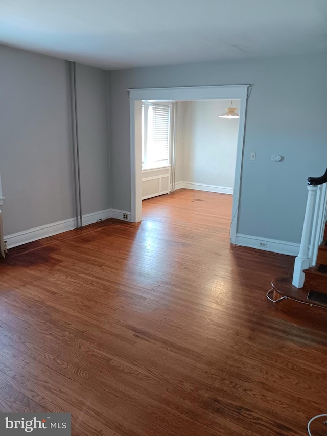 empty room with dark wood-type flooring