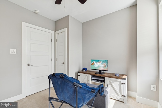 office with light carpet, ceiling fan, and baseboards