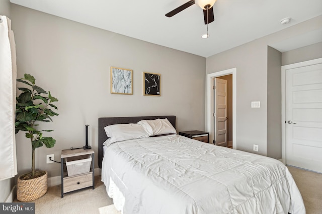 bedroom with a ceiling fan and light colored carpet