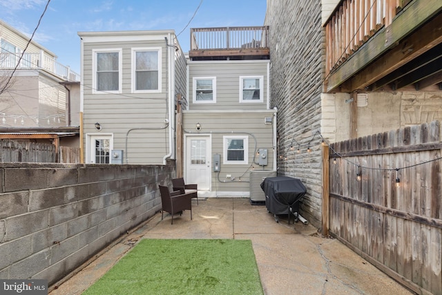 rear view of house featuring a patio area and a fenced backyard