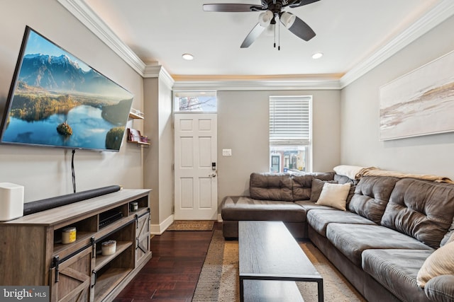 living room with ornamental molding, dark wood-type flooring, plenty of natural light, and a ceiling fan