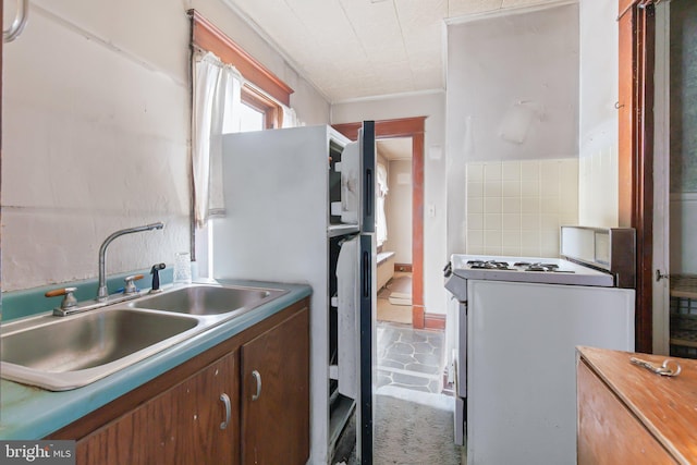 kitchen featuring sink and white range with gas stovetop