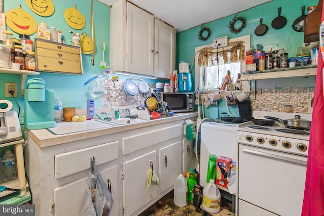 kitchen with white cabinetry and white electric range oven