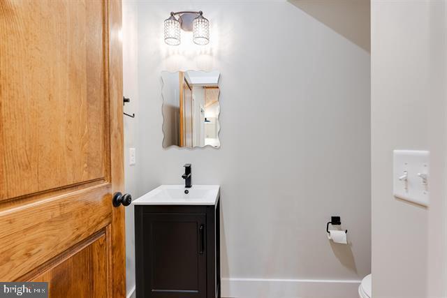 bathroom featuring vanity and toilet