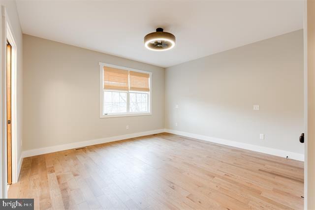 spare room featuring light hardwood / wood-style floors