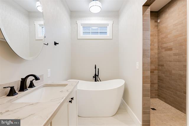 bathroom featuring vanity, separate shower and tub, and tile patterned floors