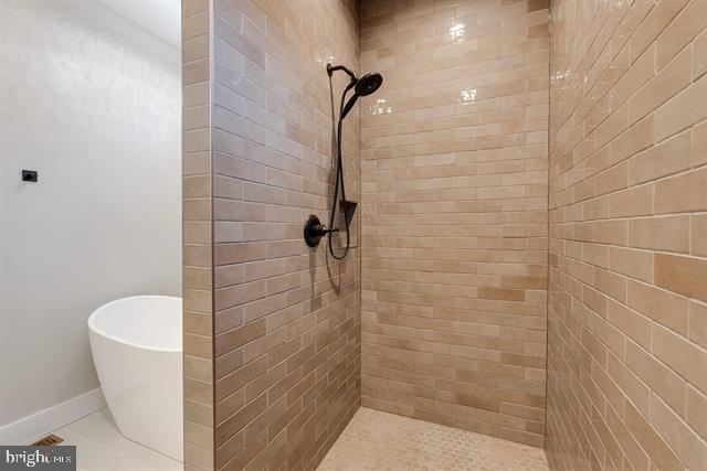 bathroom featuring shower with separate bathtub