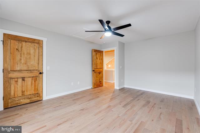 unfurnished bedroom with ceiling fan and light hardwood / wood-style flooring