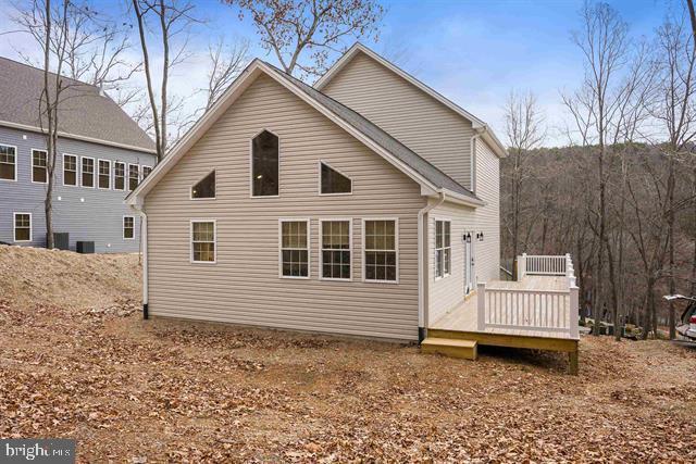 back of house featuring a wooden deck