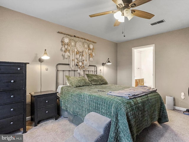 carpeted bedroom with ceiling fan and ensuite bath