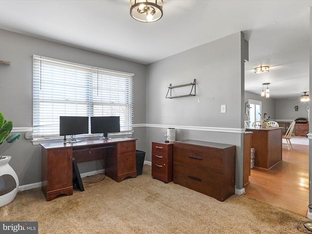 carpeted office with ceiling fan