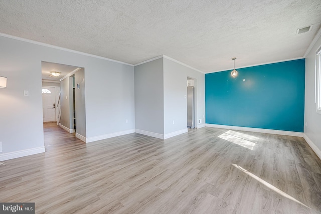 unfurnished living room featuring crown molding, a textured ceiling, and light wood-type flooring