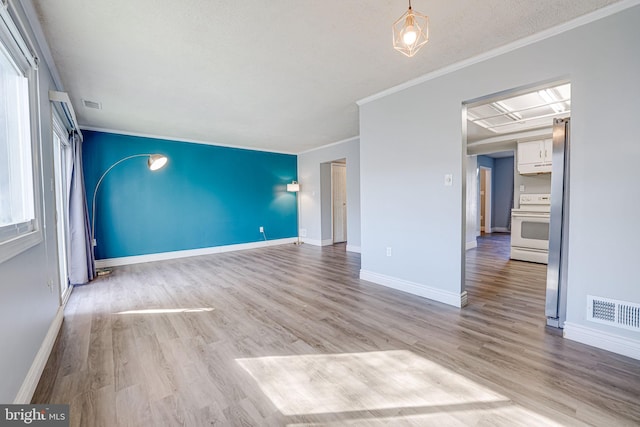 unfurnished living room with crown molding and light wood-type flooring