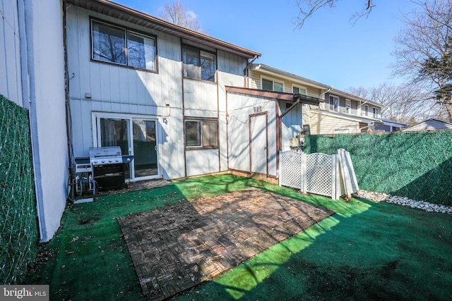 rear view of property featuring a yard