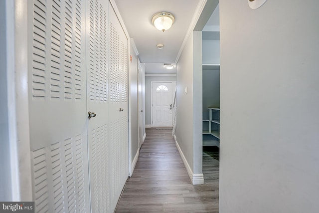 corridor with crown molding and hardwood / wood-style floors