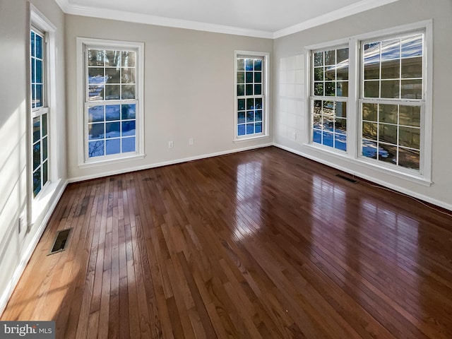 empty room with hardwood / wood-style flooring and ornamental molding