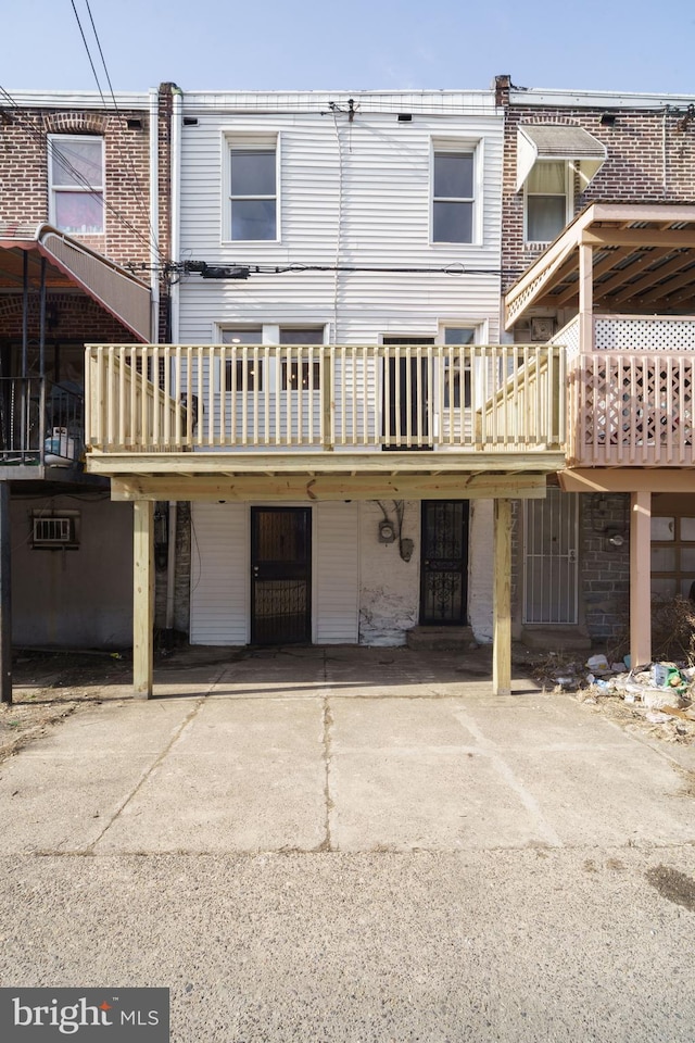 rear view of property featuring a deck