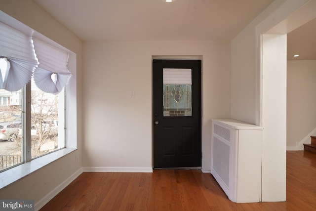 entryway featuring stairway, light wood-type flooring, and baseboards