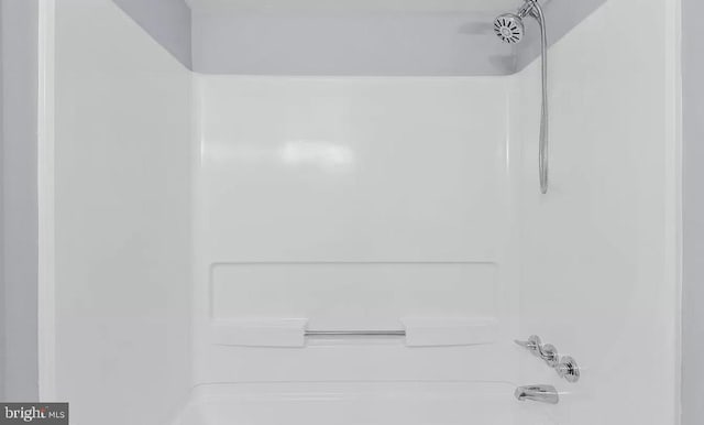 details featuring bathing tub / shower combination