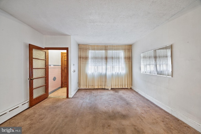 unfurnished bedroom featuring carpet floors, a textured ceiling, and a baseboard heating unit