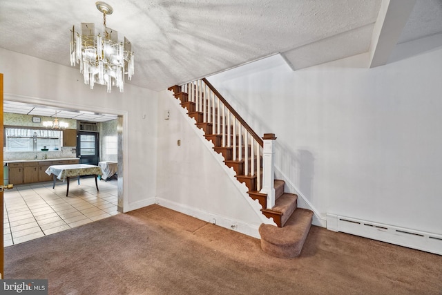 stairway with baseboard heating, carpet flooring, a chandelier, and a textured ceiling