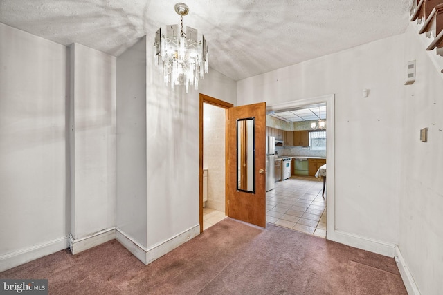 interior space featuring vaulted ceiling, a chandelier, light colored carpet, and a textured ceiling