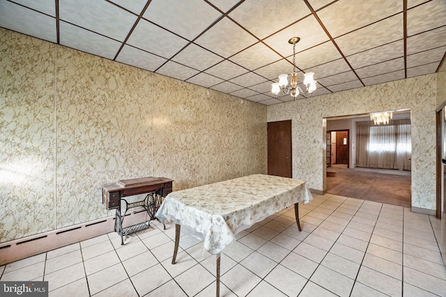 unfurnished dining area featuring an inviting chandelier and tile patterned floors