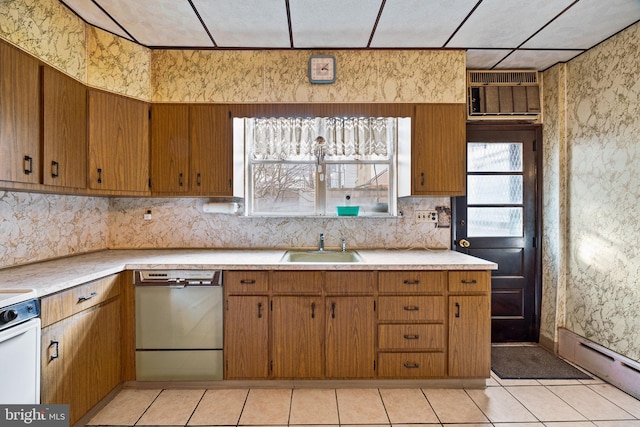 kitchen with a baseboard radiator, sink, stainless steel dishwasher, and light tile patterned floors