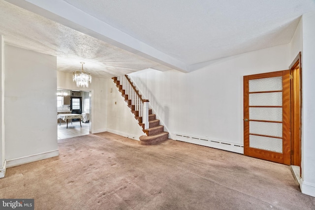 interior space with carpet floors, a baseboard radiator, a chandelier, and a textured ceiling