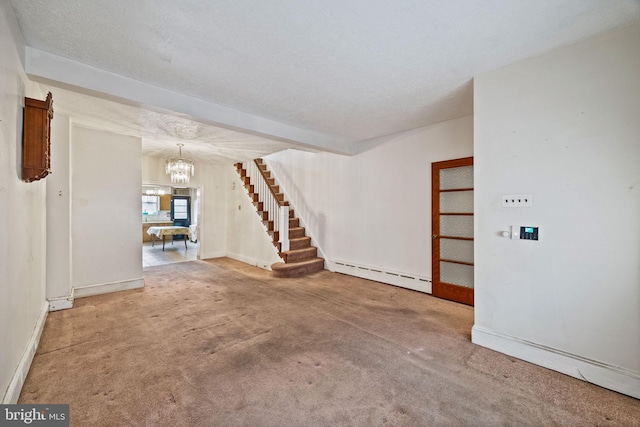 unfurnished living room with an inviting chandelier, a textured ceiling, carpet, and a baseboard heating unit