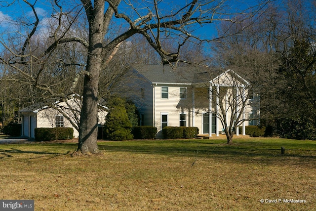 view of front of property featuring a garage and a front yard