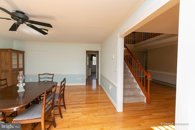 dining room with light hardwood / wood-style flooring, ornamental molding, and ceiling fan