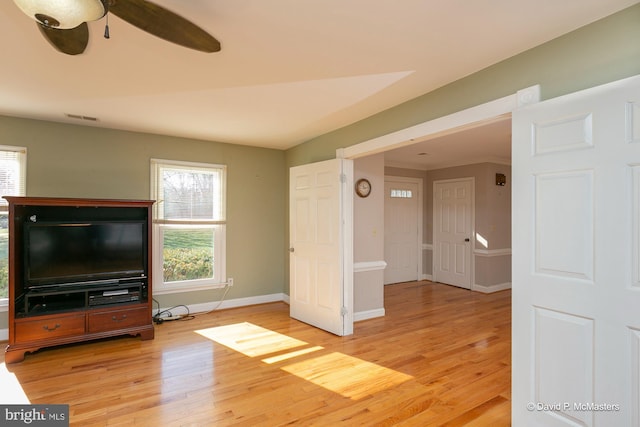 unfurnished living room featuring ceiling fan and light hardwood / wood-style flooring